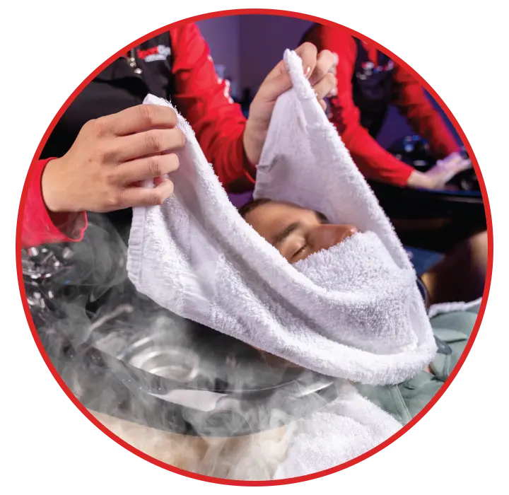 Man receiving a hot towel treatment